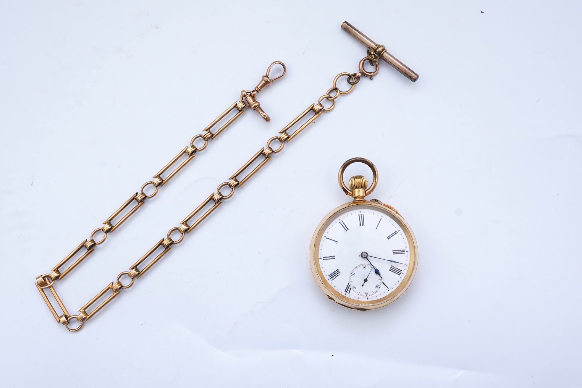 A continental 18k gold open faced keyless lever pocket watch, with a 9ct albert